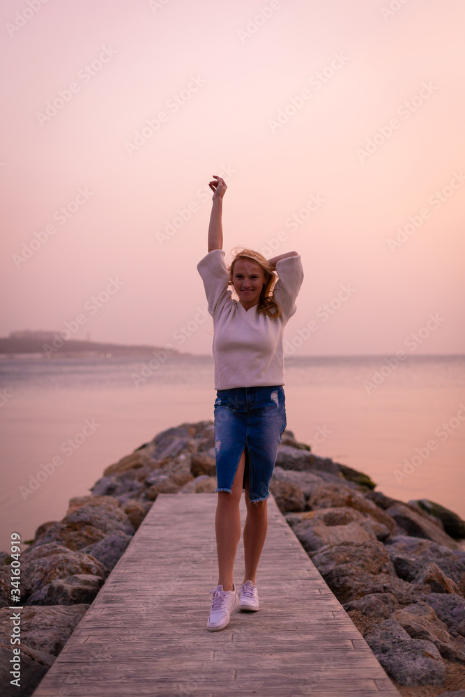 Blonde model on the beach at summer