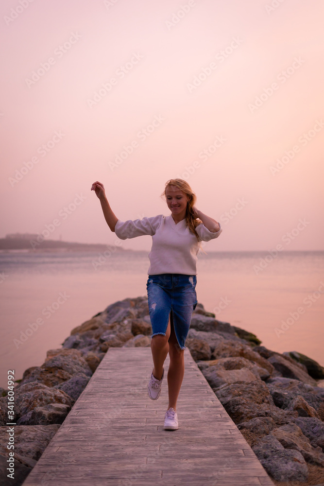 Blonde model on the beach at summer