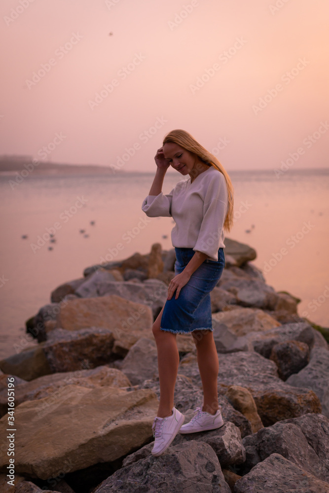 Blonde model on the beach at summer