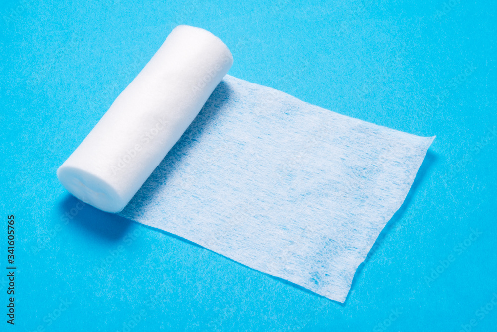 Obraz premium White roll of non woven bandage on background