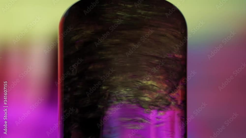 Wooden stick stirring two different liquid substances in chemistry lab