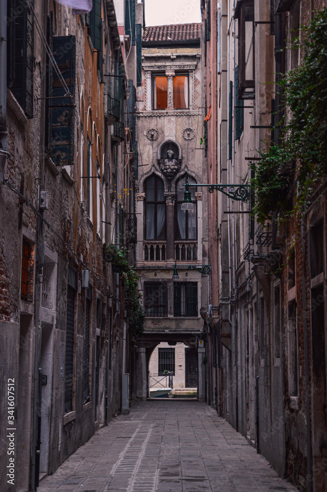 Ancient stone houses on a narrow street in Venice.