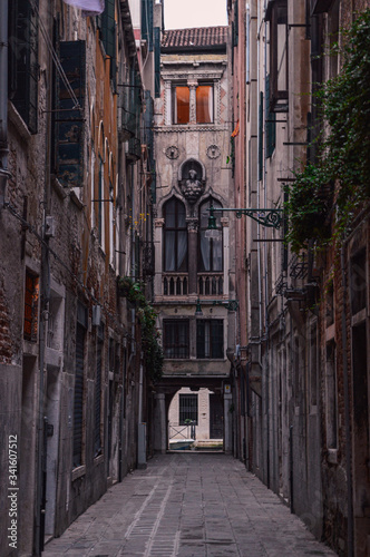 Fototapeta Naklejka Na Ścianę i Meble -  Ancient stone houses on a narrow street in Venice.
