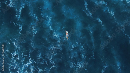 Surf Man On White Surfboard Swimming On Ocean Background. Beautiful Blue Water Space With Waves. Top View.  photo