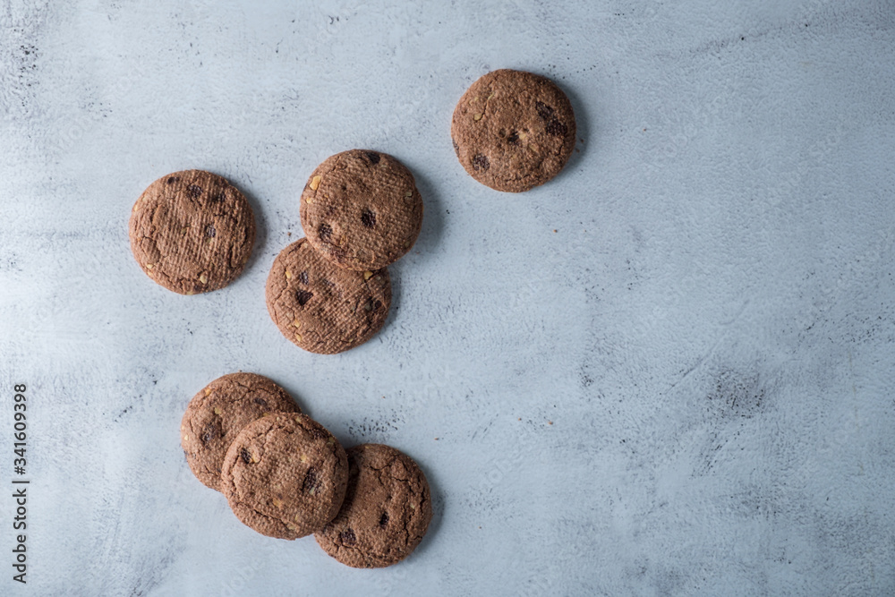 Delicious crunchy homemade chocolate cookies on light marble background. Top flat lay view Delicious crunchy homemade chocolate cookies on light marble background. Top flat lay view