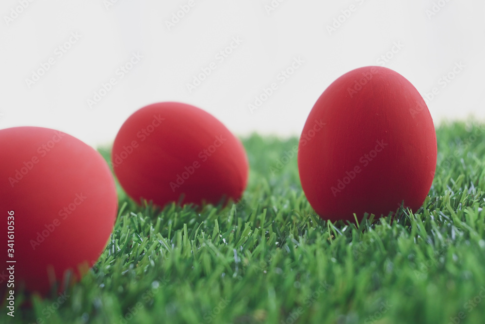 red easter egg on lawn green grass artificial with blank white background