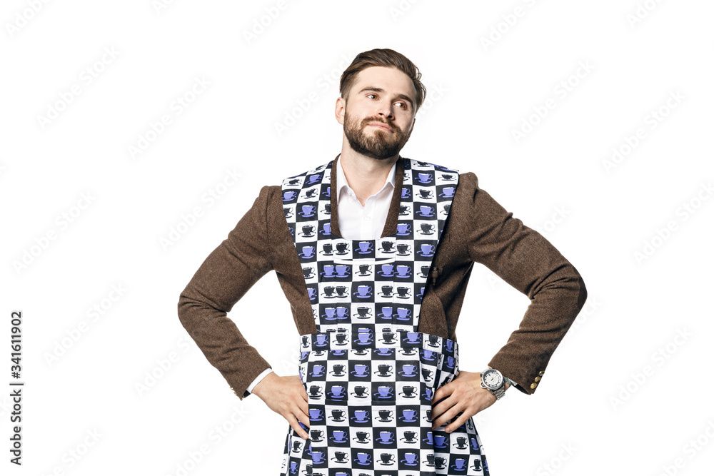 Young attractive man in a businessman suit and home apron for cleaning, dejectedly rolled his eyes and put his hands on his hips. Isolated on a white background. Young attractive man in a businessman suit and home apron for cleaning, dejectedly rolled his eyes and put his hands on his hips. Isolated on a white background.