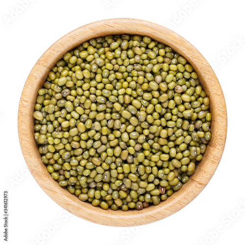 Dried mung bean (green gram, maash or moong) in wooden bowl isolated on white. Top view.