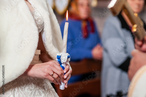 Bride holding candle in the church