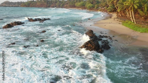 waves crashing onto rocks in nilwella beach photo