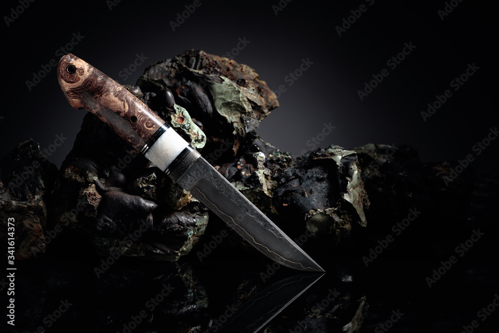 Hunter combat hand made knife and broken stones.
