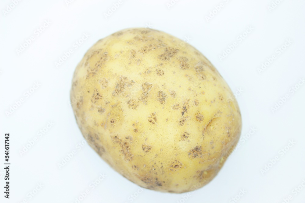 Raw ripe potatoes are located on a white background Raw ripe potatoes are located on a white background