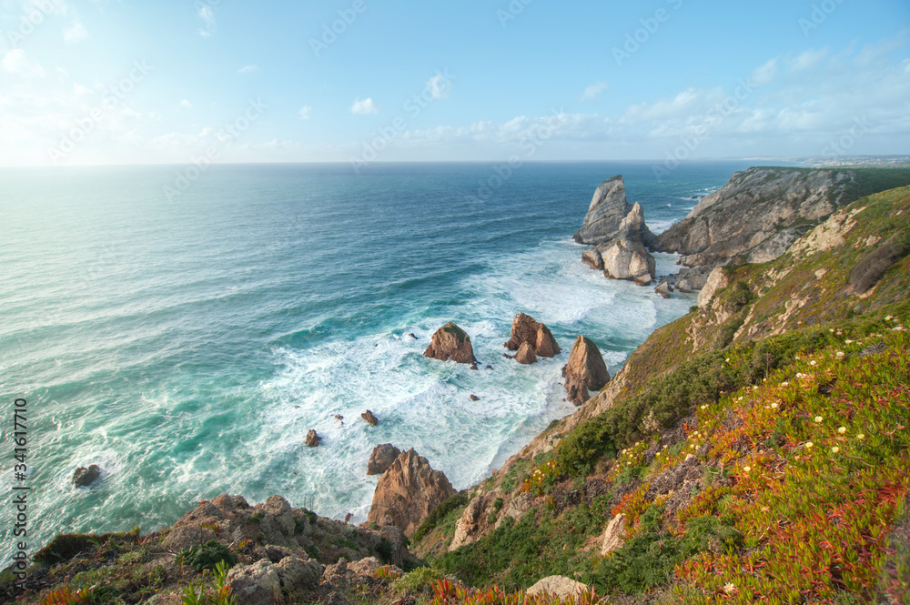 beautiful Atlantic ocean view horizon with sandy beach, rocks and waves at sunrise. . Sintra, Portugal beautiful Atlantic ocean view horizon with sandy beach, rocks and waves at sunrise. . Sintra, Portugal