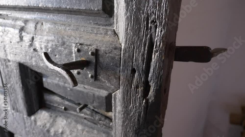 Old dark wooden door with metal handle. photo