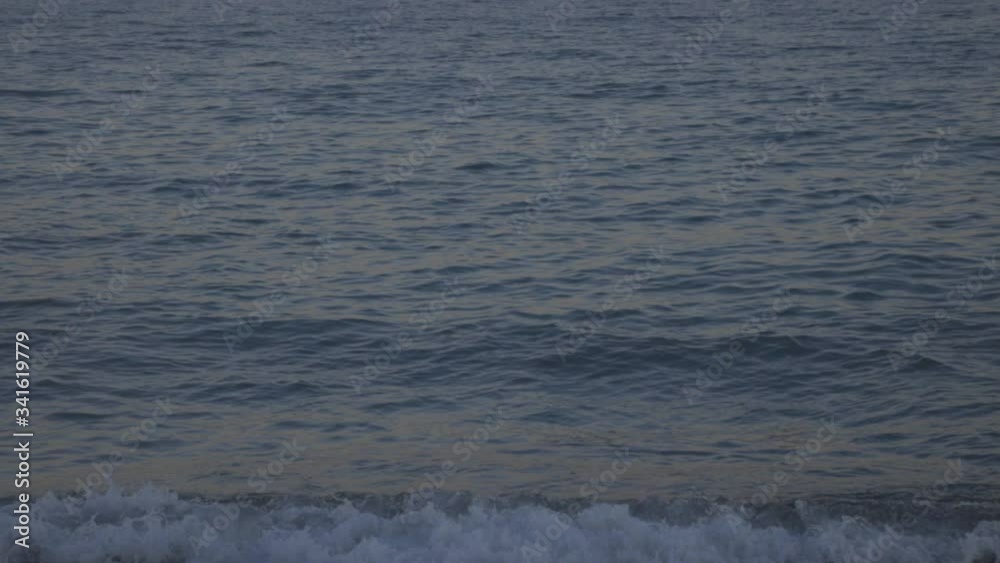 Blue Sea Wave On The Sandy Shore During The Golden Hour.- medium shot Blue Sea Wave On The Sandy Shore During The Golden Hour.- medium shot