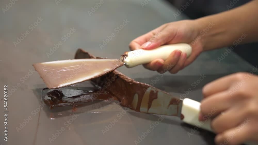 Scraping melted Chocolate off Spatula. Scraping melted Chocolate off Spatula.