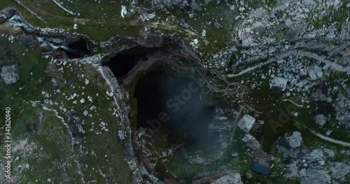 Dramatic aerial rising shot directly above a deep dark spooky hole in the earth, Tannourine, Lebanon photo