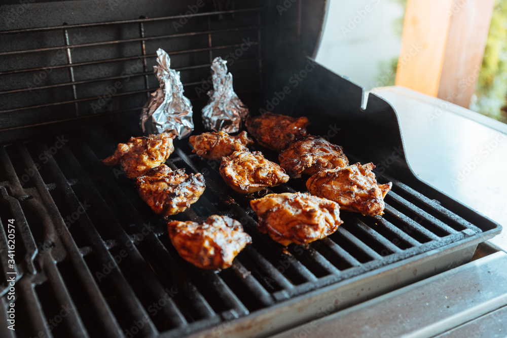 Grilling chicken thighs on a gas grill Stock Photo Adobe Stock