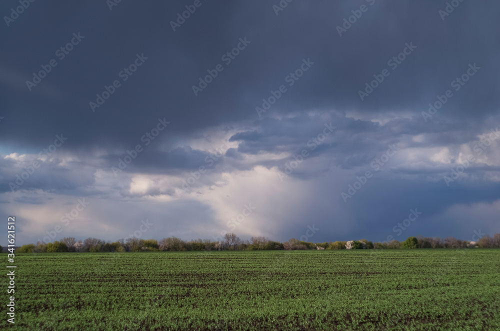 Spring stormy sky with clouds before the rain. Sky and field landscape.
Spring stormy sky with clouds before the rain. Sky and field landscape.