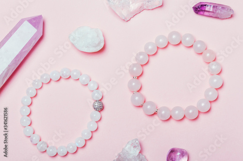 rose quartz semiprecious bracelet on pink background photo