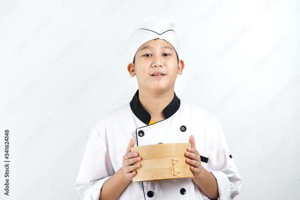 Young Asian chef holding dumpling in his hand. Young Asian chef holding dumpling in his hand.