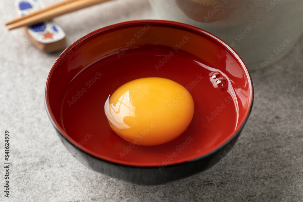 Japanese raw egg in a bowl close up Japanese raw egg in a bowl close up