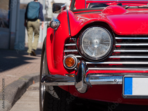 Front light of the red vintage car.
