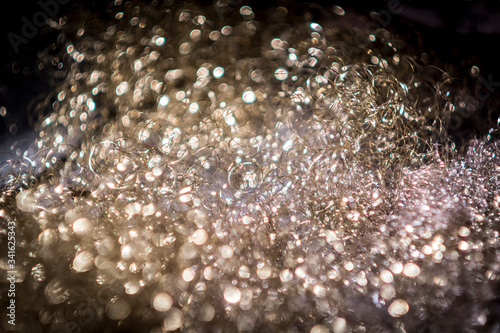 Soap bubbles in a foam carpet with blurred areas in the foreground and background