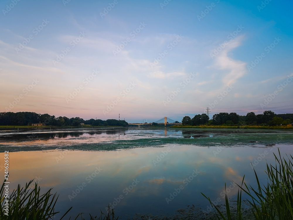 Naklejka premium Landscape with colorful sky reflecting in river