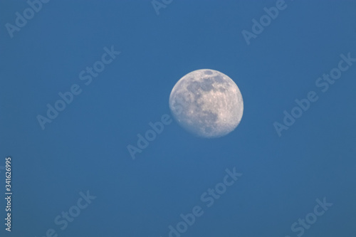 Mond  luna  kurz vor Vollmond  vor blauem Hintergrund  am Tag  blauer  wolkenloser Himmel  freier Raum links und unten