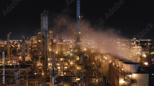 Wallpaper Mural Drone flight over the territory of huge petroleum refinery. Clouds of smoke rise from numerous factory pipes. All constructions are illuminated by factory lighting. The sky is totally black. Aerial,4K Torontodigital.ca