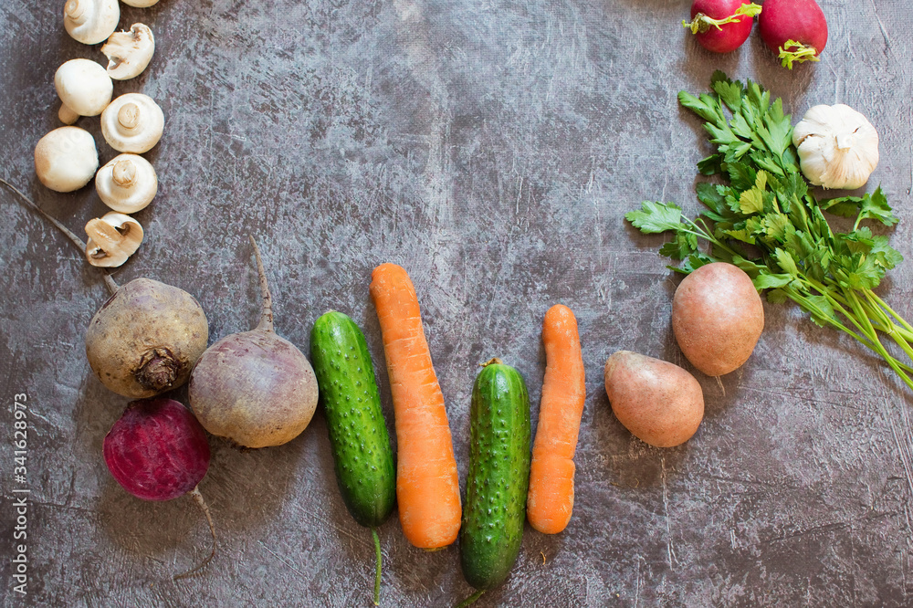Composition with fresh vegetables on grey background, space for text.