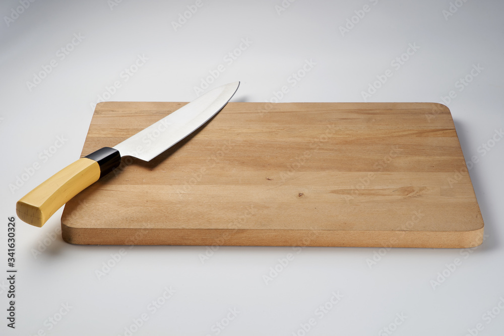 Knife on chopping board isolated over white background