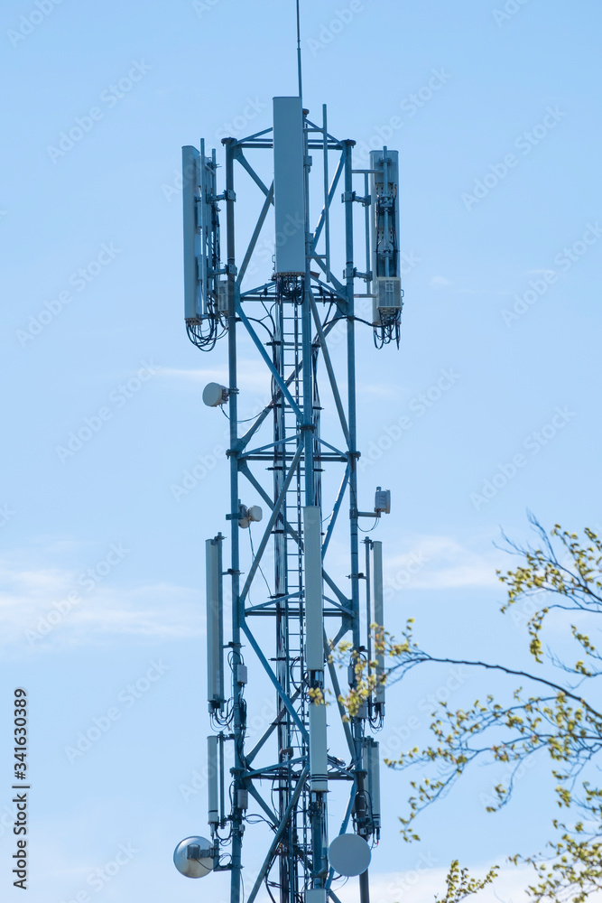 5G Network Connection Concept-5G smart cellular network antenna base station on the telecommunication mast. at a blue sky in a green environment 5G Network Connection Concept-5G smart cellular network antenna base station on the telecommunication mast. at a blue sky in a green environment