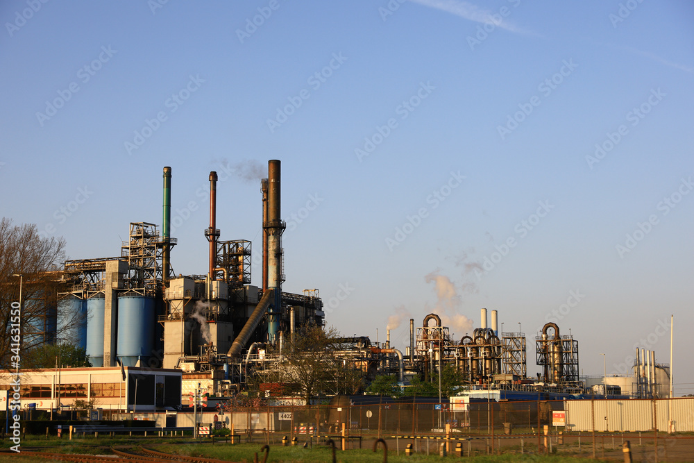  Industrial landscape, factory building in the Netherlands. Heavy industry in Europe, petrochemical industrial plant power station at sunset, pollution from smokestacks, ecology problems.