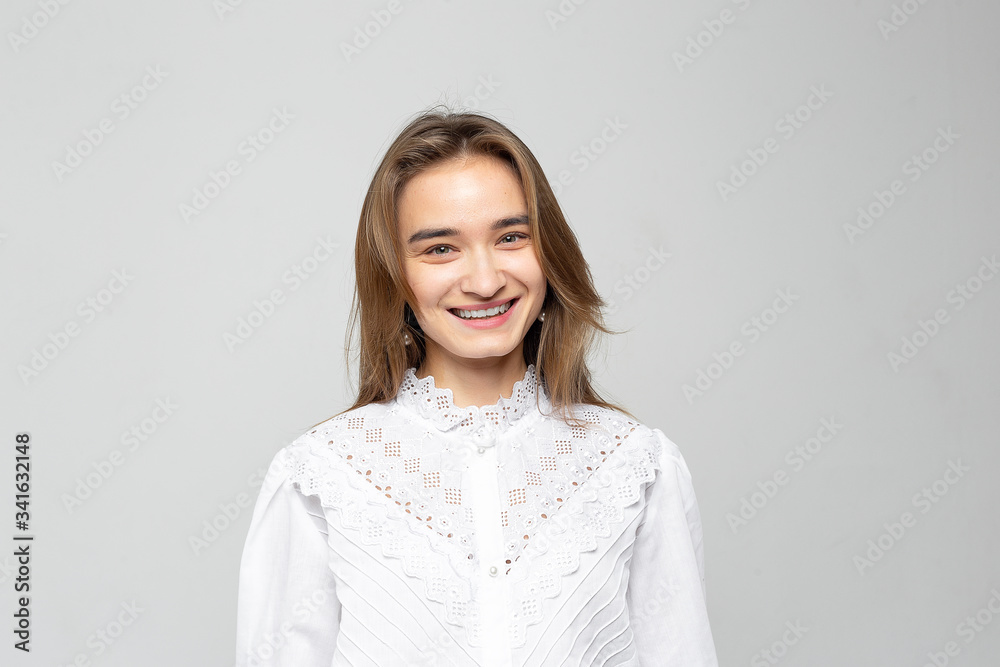 Beautiful young woman portrait. Studio shot, isolated on gray background Beautiful young woman portrait. Studio shot, isolated on gray background