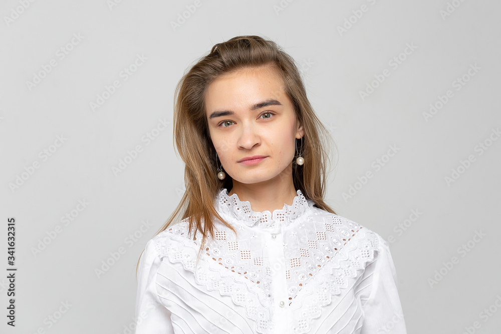 Beautiful young woman portrait. Studio shot, isolated on gray background Beautiful young woman portrait. Studio shot, isolated on gray background