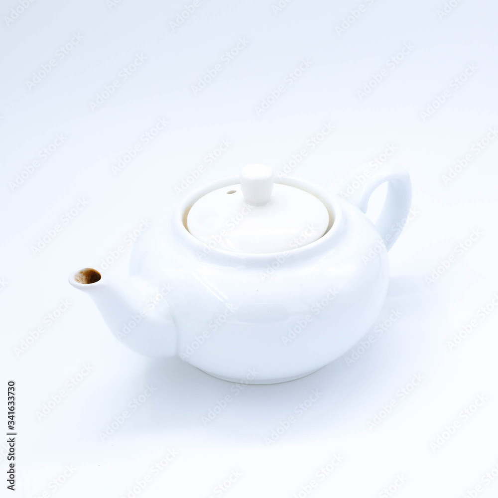 cup with tea and teapot on white background, over light
cup with tea and teapot on white background, over light