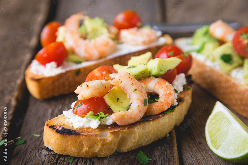 Sandwich with vegetables and prawns. Bruschetta with avocado and shrimp