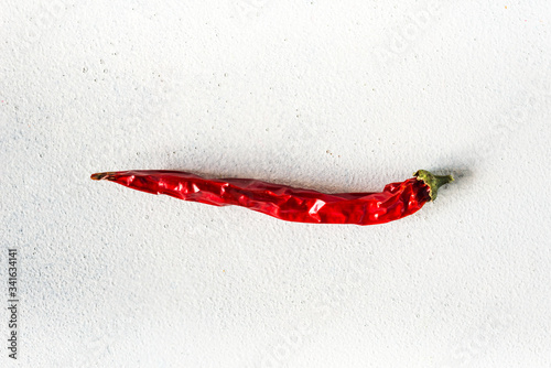 
dried ugly red chili peppers against a light background close-up