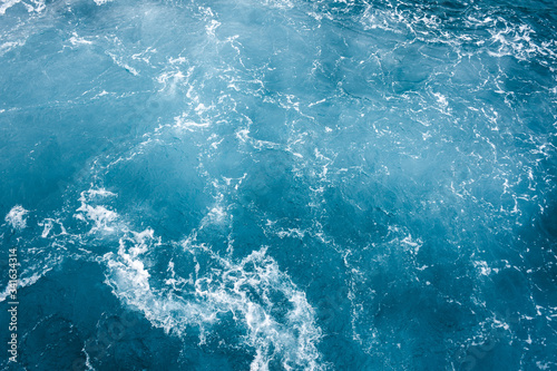 Blue ocean water texture, surface. Top view of aqua blue clear sea ocean. Beautiful blue sea water background.