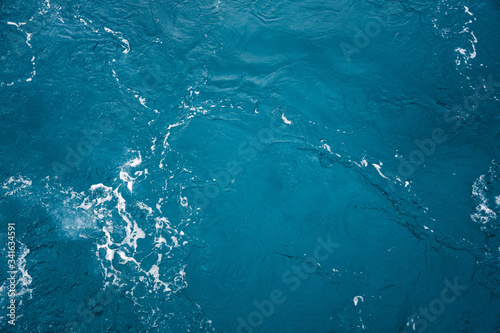 Blue ocean water texture, surface. Top view of aqua blue clear sea ocean. Beautiful blue sea water background.