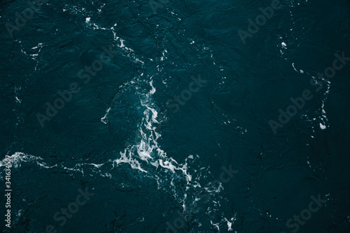 Blue ocean water texture, surface. Top view of aqua blue clear sea ocean. Beautiful blue sea water background. © Pornthep