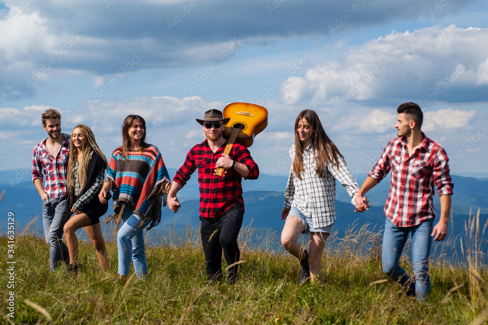 Group of people having fun on mountain against mountains. Travel, adventure or expedition concept. Group walking. Group of hikers walking in mountains. Group of people having fun on mountain against mountains. Travel, adventure or expedition concept. Group walking. Group of hikers walking in mountains.