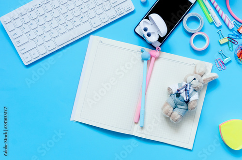 Online education concept. School supplies on blue background. photo