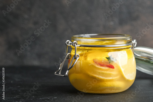 Картината върху платно Salted lemons in glass jar on a dark background