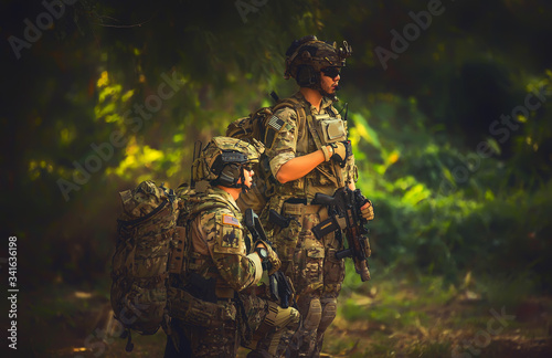 Special forces. soldier assault rifle with silencer. sniper in the forest. 