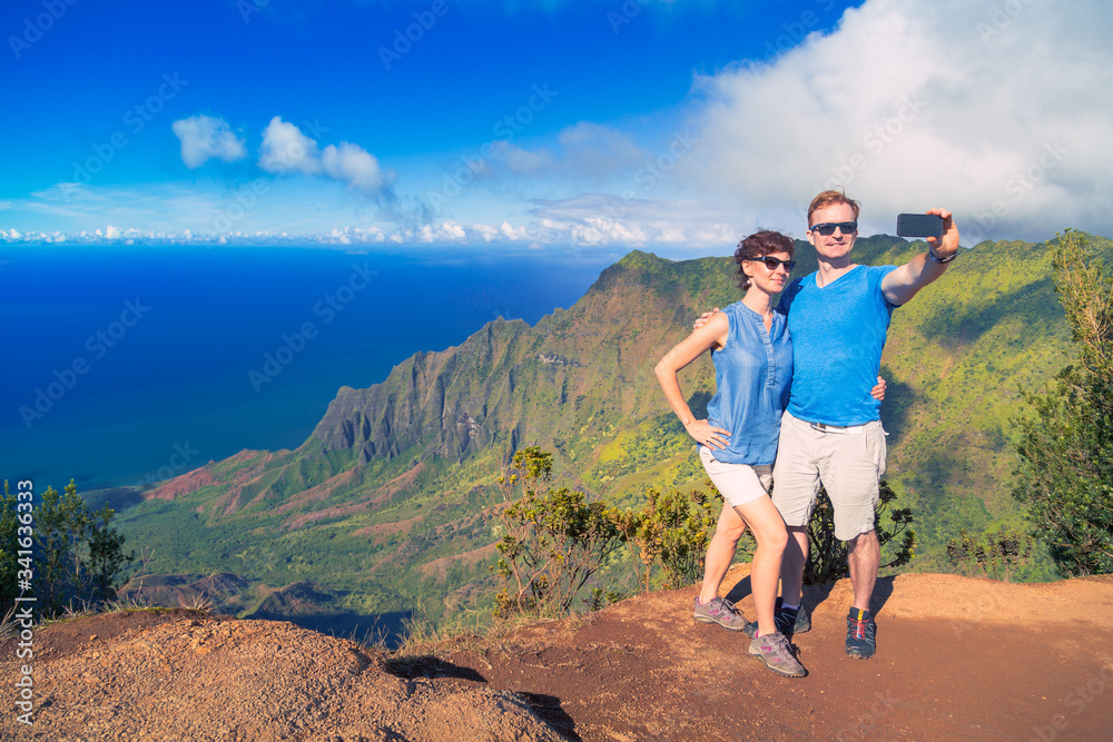 Couple of tourists in Na Pali, Kauai, Hawaii