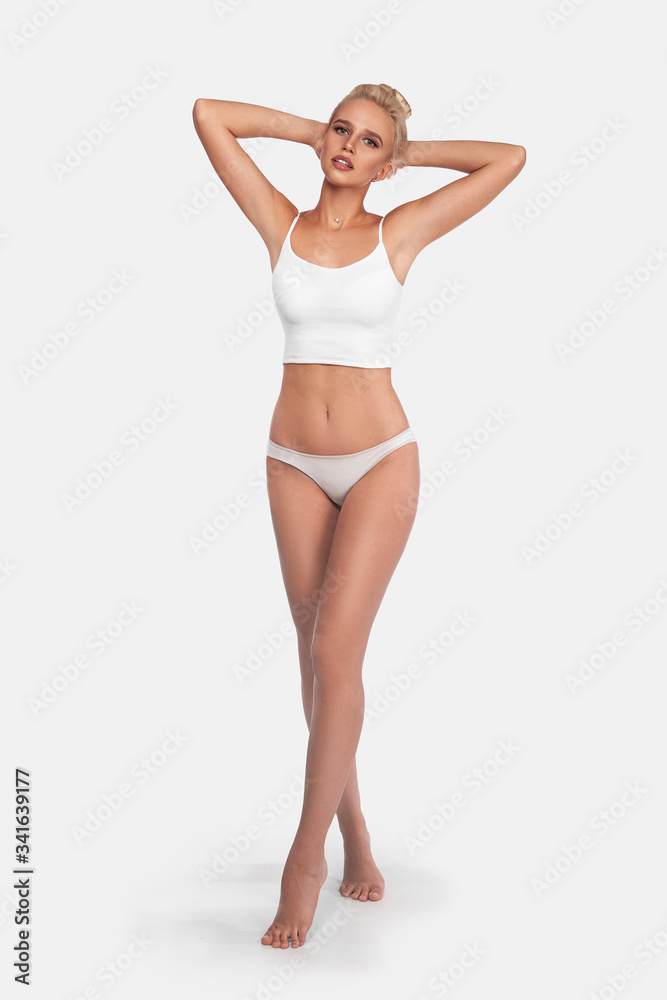 Young, slim, healthy and beautiful blonde woman in white lingerie. Sport, fitness, diet, weight loss and healthcare concept. Mockup. Young, slim, healthy and beautiful blonde woman in white lingerie. Sport, fitness, diet, weight loss and healthcare concept. Mockup.