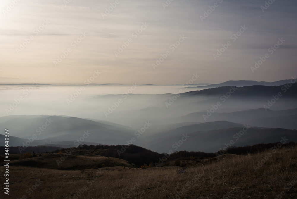 Low clouds over the mountains at sunset. (12000px)